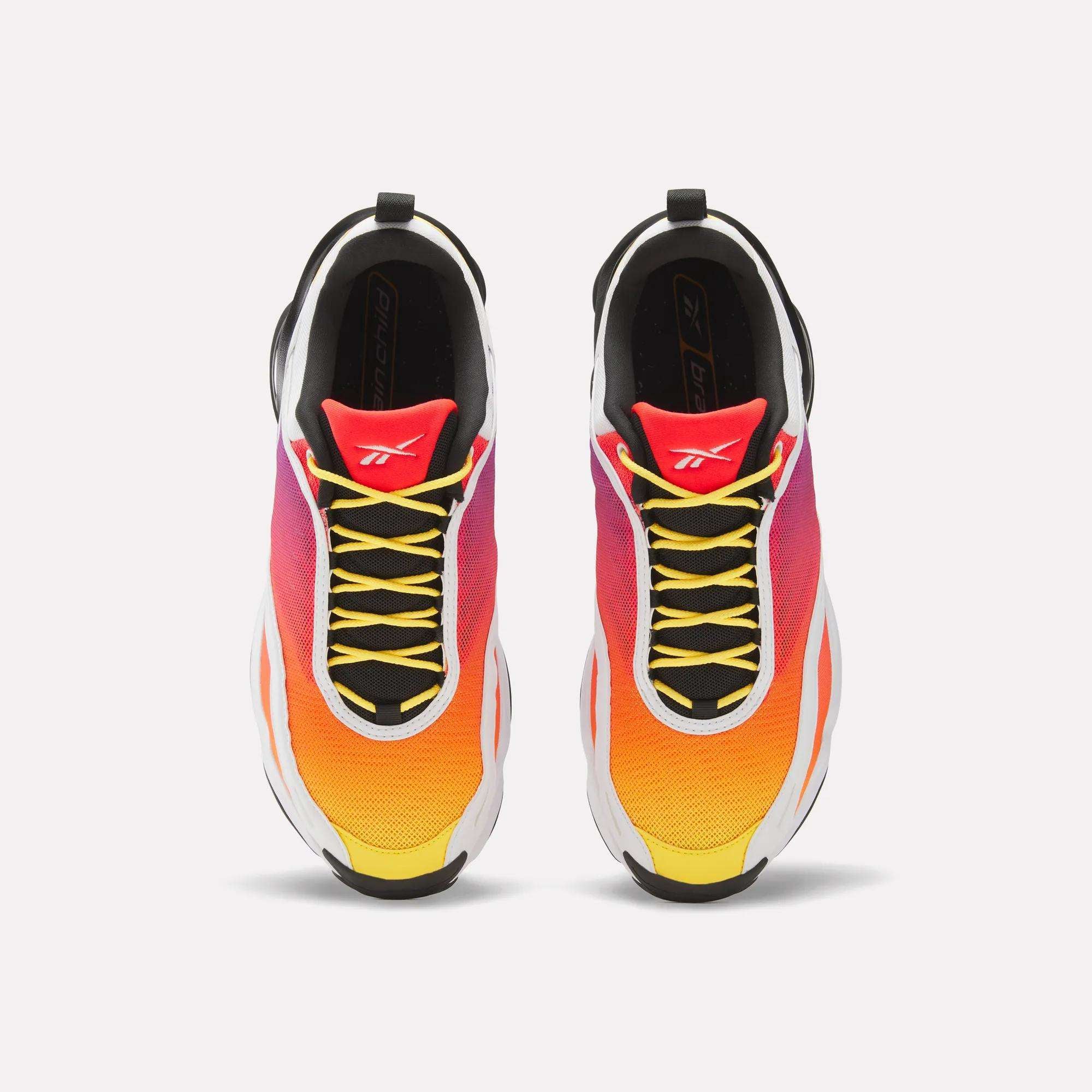 Top view of Reebok x Brain Child DMX Series 3000 Shoes with a yellow-to-orange-pink gradient, black laces, white midsoles, red tongues with a white logo, and responsive cushioning for all-day comfort.