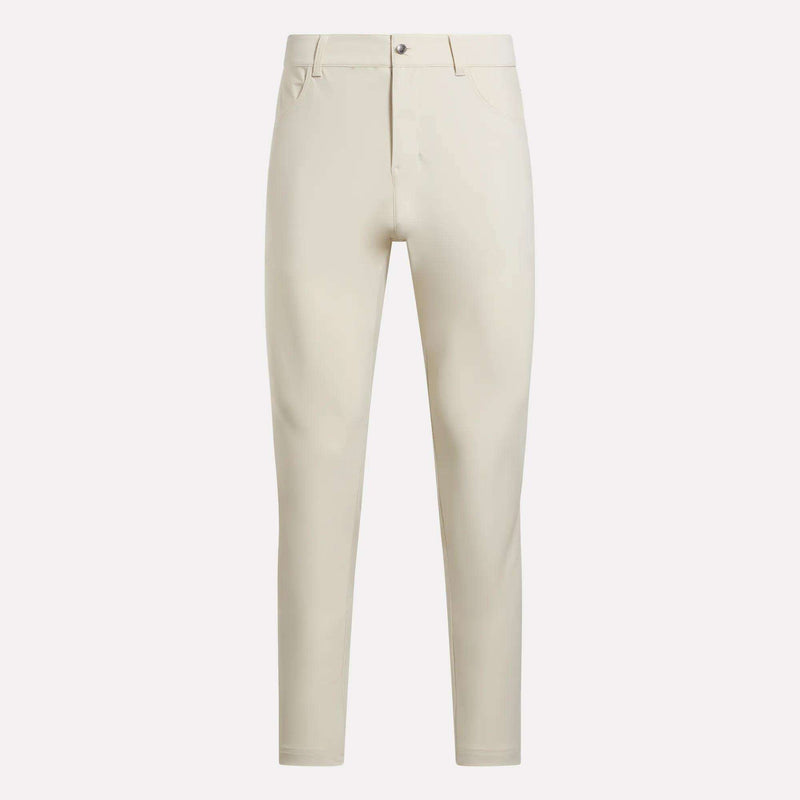 The Reebok Men's Favorite 5-Pocket Relaxed Fit Golf Pants, in light beige wrinkle-resistant fabric with belt loops, button closure, and front pockets, are shown against a plain white background.
