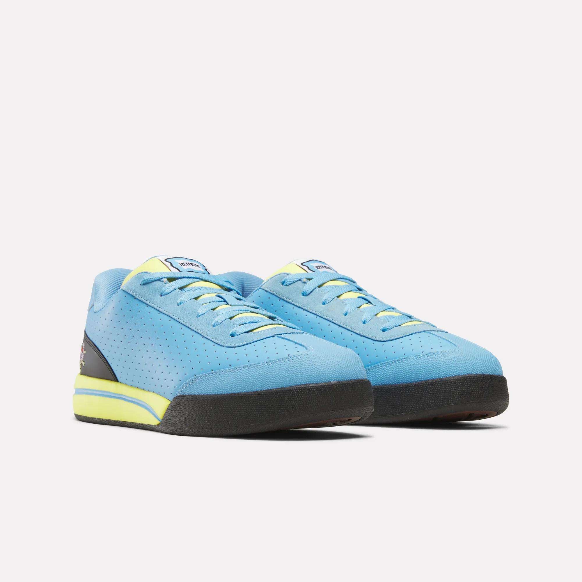 The Reebok x Icecream Board Flip Shoes by Reebok feature light blue uppers, yellow accents on the laces and midsole, black soles, and a subtle perforated side pattern for that early-2000s skate style.