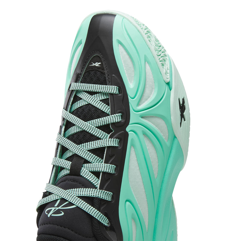 Close-up of the Reebok Angel Reese 1 Basketball Shoes for big kids, showcasing mint green and black accents, patterned laces, mesh material, and a textured sole with Reebok logos on the tongue and side—perfect for those seeking stylish kids basketball shoes.