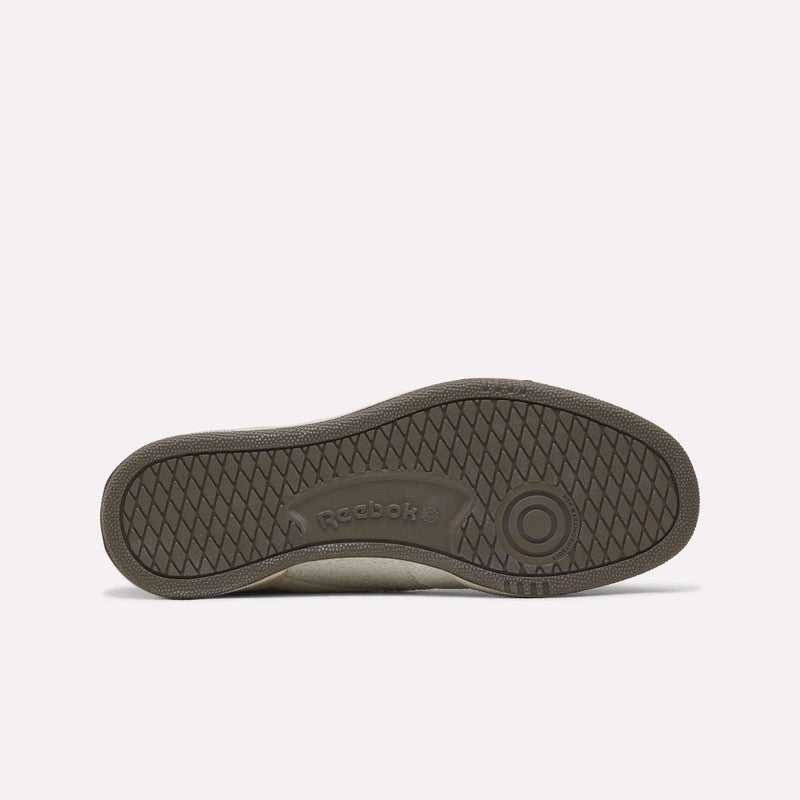 The brown rubber sole of a Reebok x Avatar Club C 85 Shoes sneaker featuring a textured tread pattern.