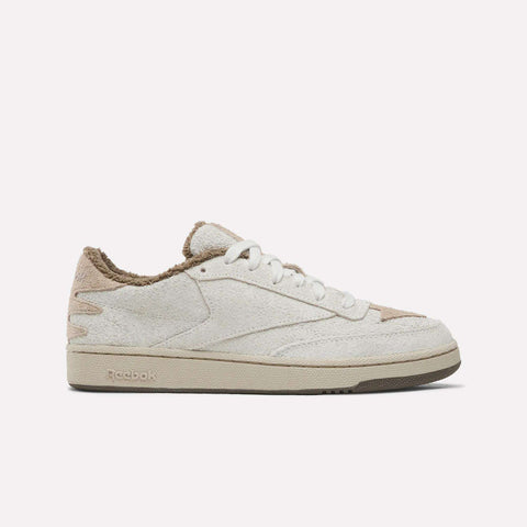 Reebok x Avatar Club C 85 Shoes in off-white hairy suede with a tan fuzzy lining, brown detailing at the heel and toe, and a tan rubber sole.