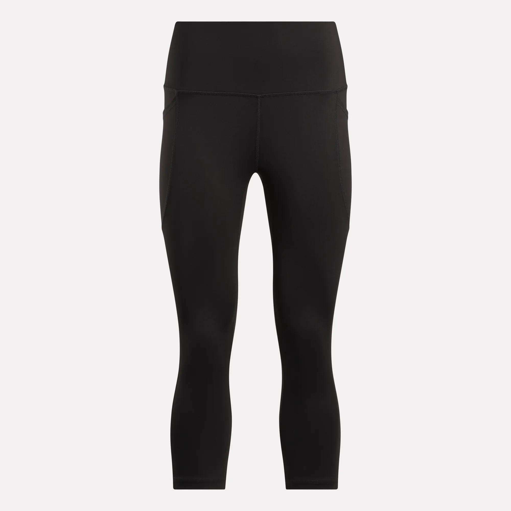 Women's Capri Leggings by Reebok in black, featuring a high waist, ankle length, side pockets, and an adjustable waistband. Shown on a plain white background.