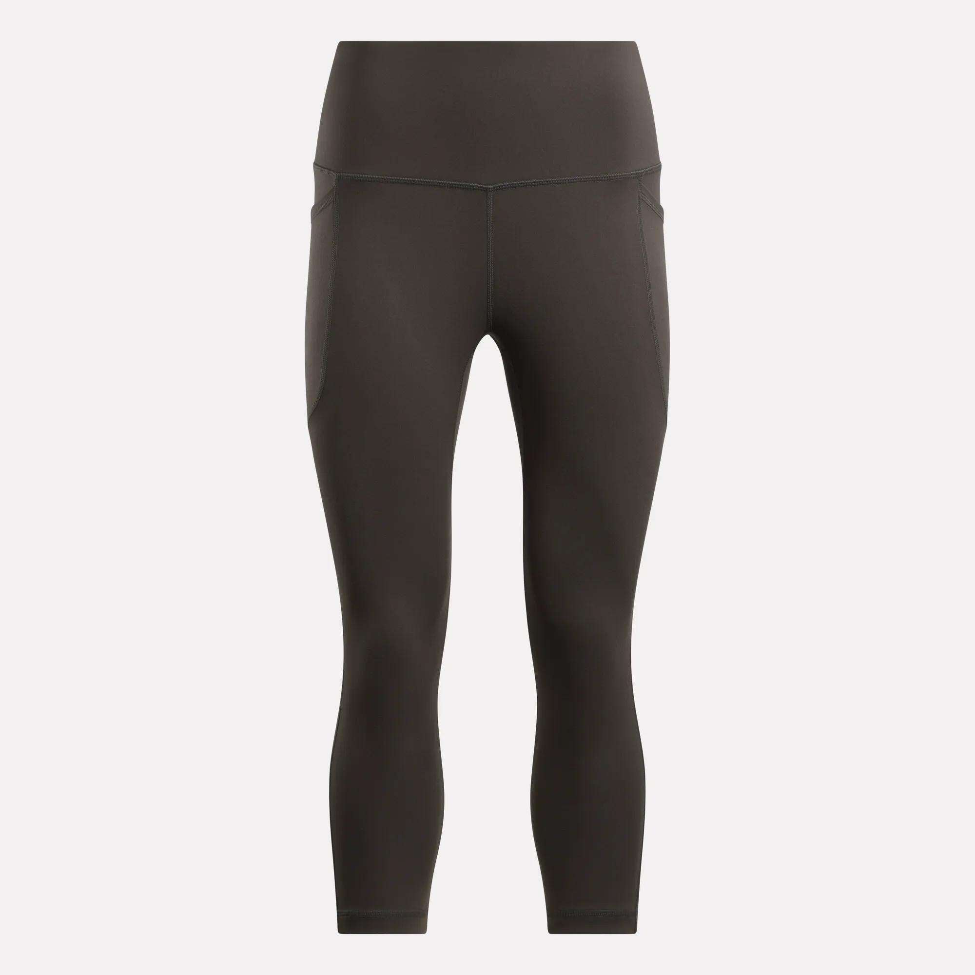 Reebok Women's Capri Leggings in black, shown on a plain light background. These fitted, high-waisted leggings offer a smooth finish, subtle seam details, and ankle-length style—ideal for any fitness routine.