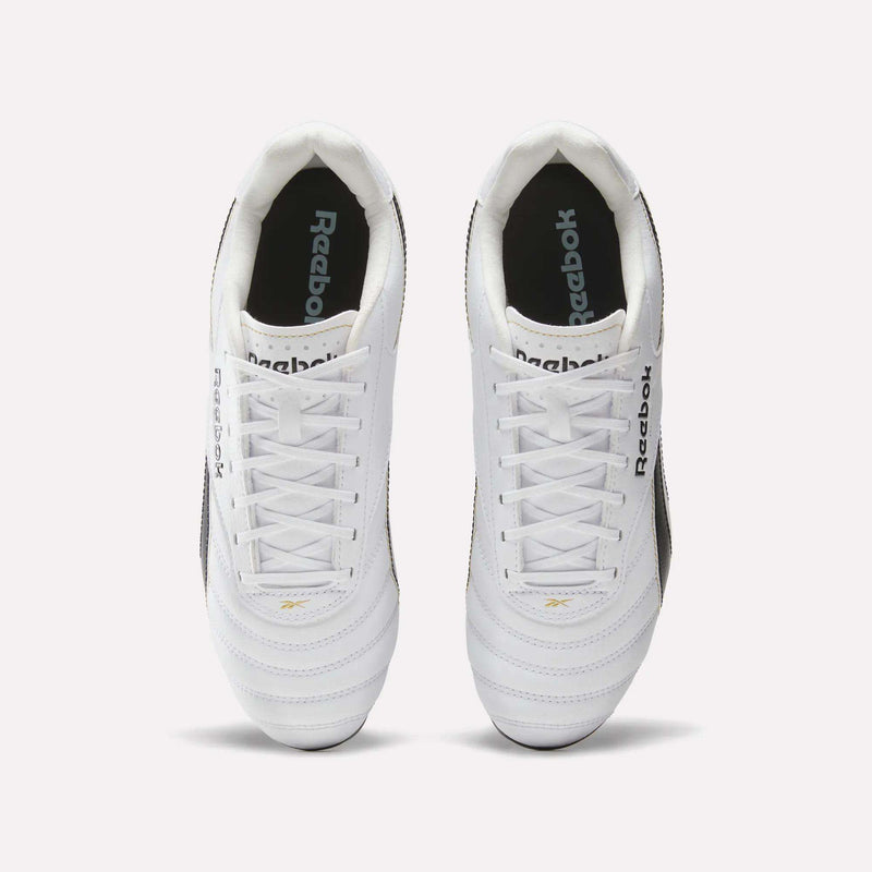 A pair of RBK800 League Firm Ground Soccer Cleats by Reebok in white with black detailing, viewed from above. The Reebok logo appears on both the tongue and insole of each shoe. Featuring white laces and classic stitching, these cleats offer timeless style alongside the trusted quality of Reebok.