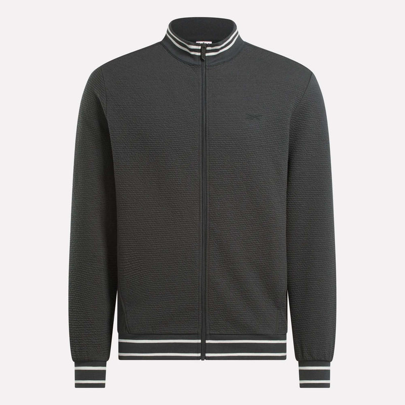 The Men's Club Sport Textured Jacket by Reebok is a black thermal knit jacket with a sporty, minimalist design and features white and black striped ribbed collar, cuffs, and waistband. No visible logos or patterns for a clean look.