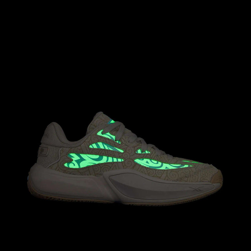 Reebok x Avatar Engine A 26 basketball shoes featuring a low-top silhouette, a patterned tan upper, and glowing green tribal-style accents.