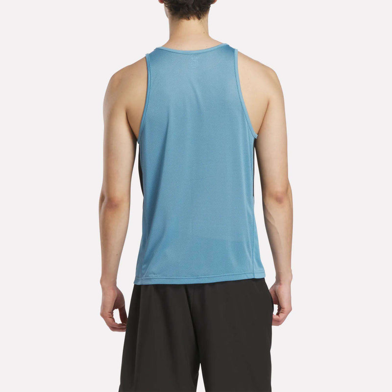 A person is seen from behind wearing a light blue Reebok Men's Run Speedwick Singlet and black shorts, standing against a plain white background.