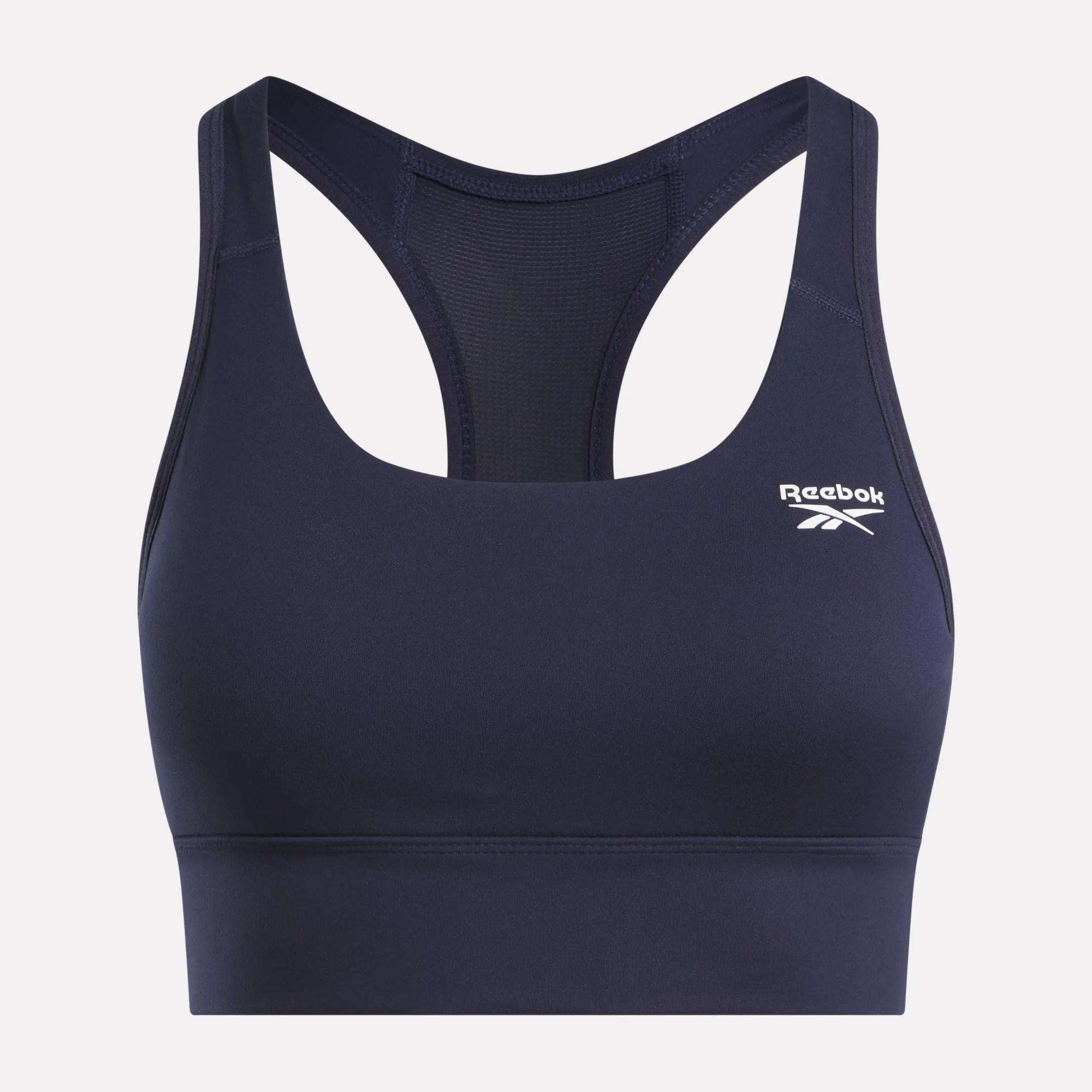 The Reebok Women's Rush Medium-Impact Sports Bra features a navy blue racerback design, mesh back panel, and a white logo on the left chest—perfect for medium-impact workouts.