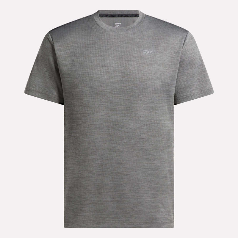 The Reebok Men's Director Short Sleeve Top is a plain gray training t-shirt with a subtle left-chest logo, shown on a light background. Its stretchy fabric makes it ideal for men's workout routines.