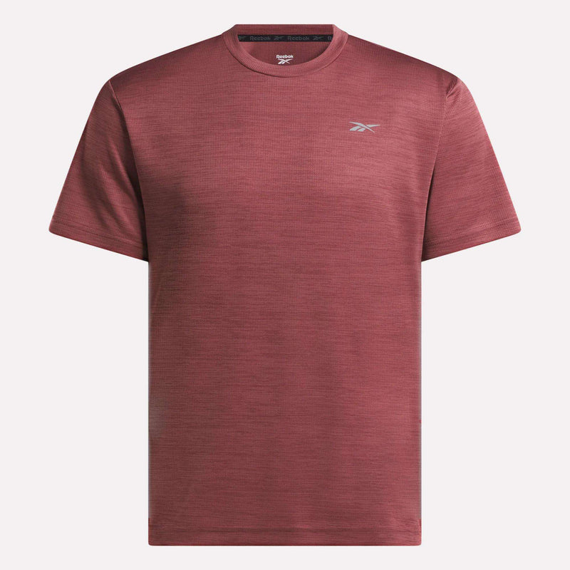 The Reebok Men's Director Short Sleeve Top is a plain maroon training t-shirt with short sleeves and a small white logo on the left chest, shown on a white background. Its stretchy fabric makes it ideal for any workout.