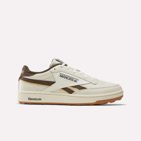 The Reebok x Manors Club C Revenge Golf Shoes by Reebok are shown in Vintage Chalk, Espresso, and Reebok Gum. These stylish golf sneakers feature MANORS branding on the side, a gum sole, and brown accents on the heel, tongue, and side stripe, displayed against a plain white background.