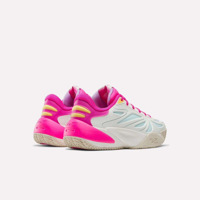 The Reebok x Barbie x Angel Reese 1 Shoes - Big Kids, by Reebok, feature crisp white uppers with vibrant Barbie pink basketball-inspired accents, yellow detailing, and beige textured soles. Photographed against a light background, the sneakers are angled to display both their sides and backs.