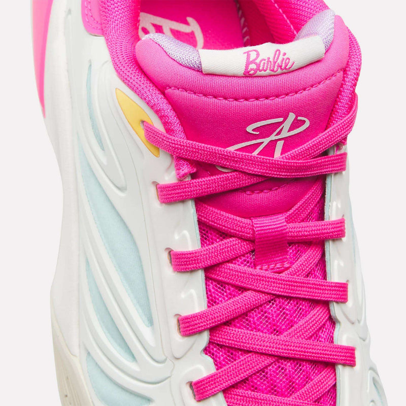 Close-up of the Reebok x Barbie x Angel Reese 1 Shoes for Big Kids, featuring pink laces, mesh, and tongue. The tongue displays "Barbie" in white script, reflecting Angel Reese’s signature style. White and light blue accents complete this playful Reebok design.