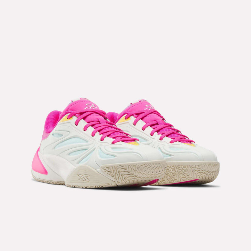 A pair of Reebok x Barbie x Angel Reese 1 Shoes for big kids, in white with pink accents, pink laces, and cream-colored soles, are displayed side by side on a white background—these sneakers from Reebok capture the playful style inspired by iconic Barbie basketball shoes.