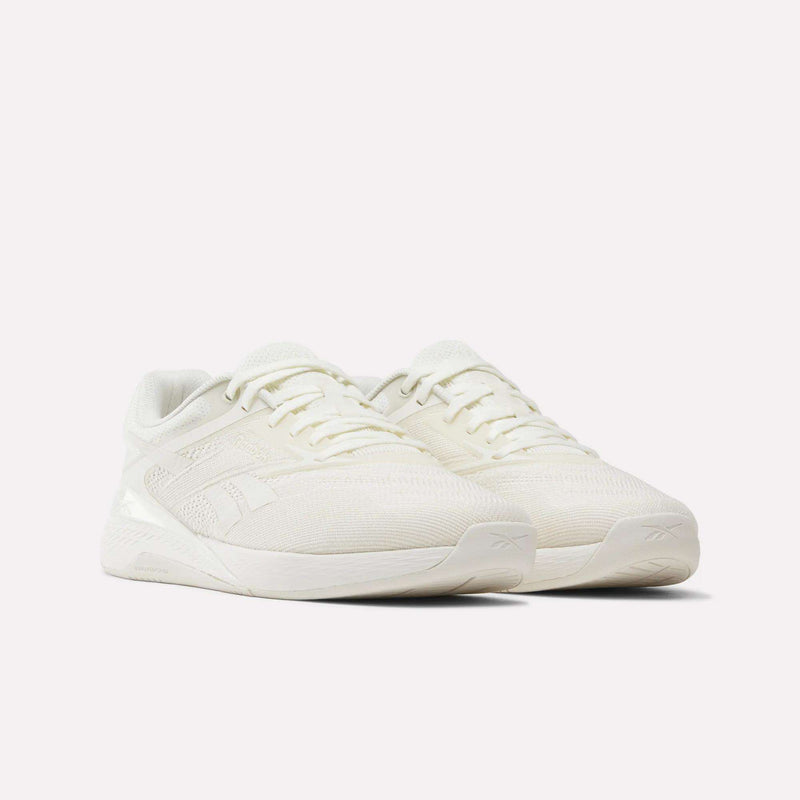 A pair of Reebok Nano X5 Training Shoes in off-white, featuring low-profile mesh uppers, textured side details, and thick rubber soles, displayed on a plain white background.