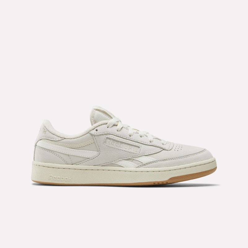 The Reebok Men's Club C Revenge Shoes feature a beige nubuck leather upper, low-top tennis silhouette, subtle stitching, and a light tan rubber sole, shown against a plain white background.
