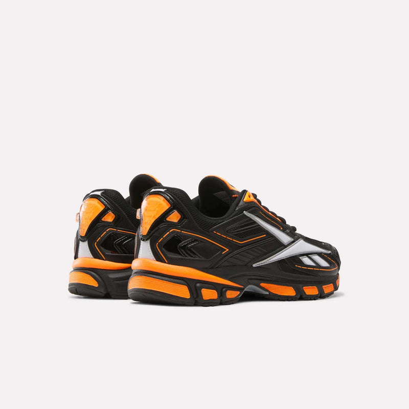 A pair of Reebok Premier Road Ultra SV Running Shoes in black with bright orange and silver accents, shown from the back and side on a plain white background.