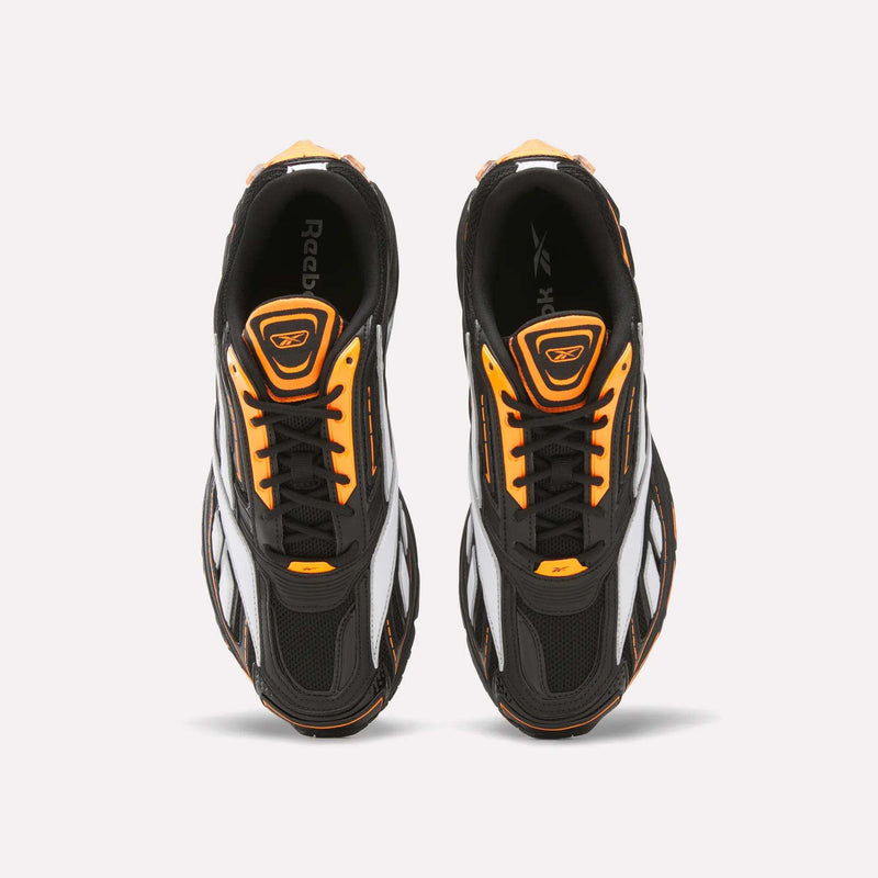 Top view of a pair of Reebok Premier Road Ultra SV Running Shoes in black with white and orange accents, featuring a retro-inspired design, placed side by side on a light background.