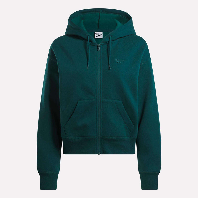 The Reebok Women's Cropped Full-Zip Hoodie in dark green features a cozy knit fabric, hood, front zipper, roomy pockets, and a small embroidered logo on the left chest, shown against a plain white background.