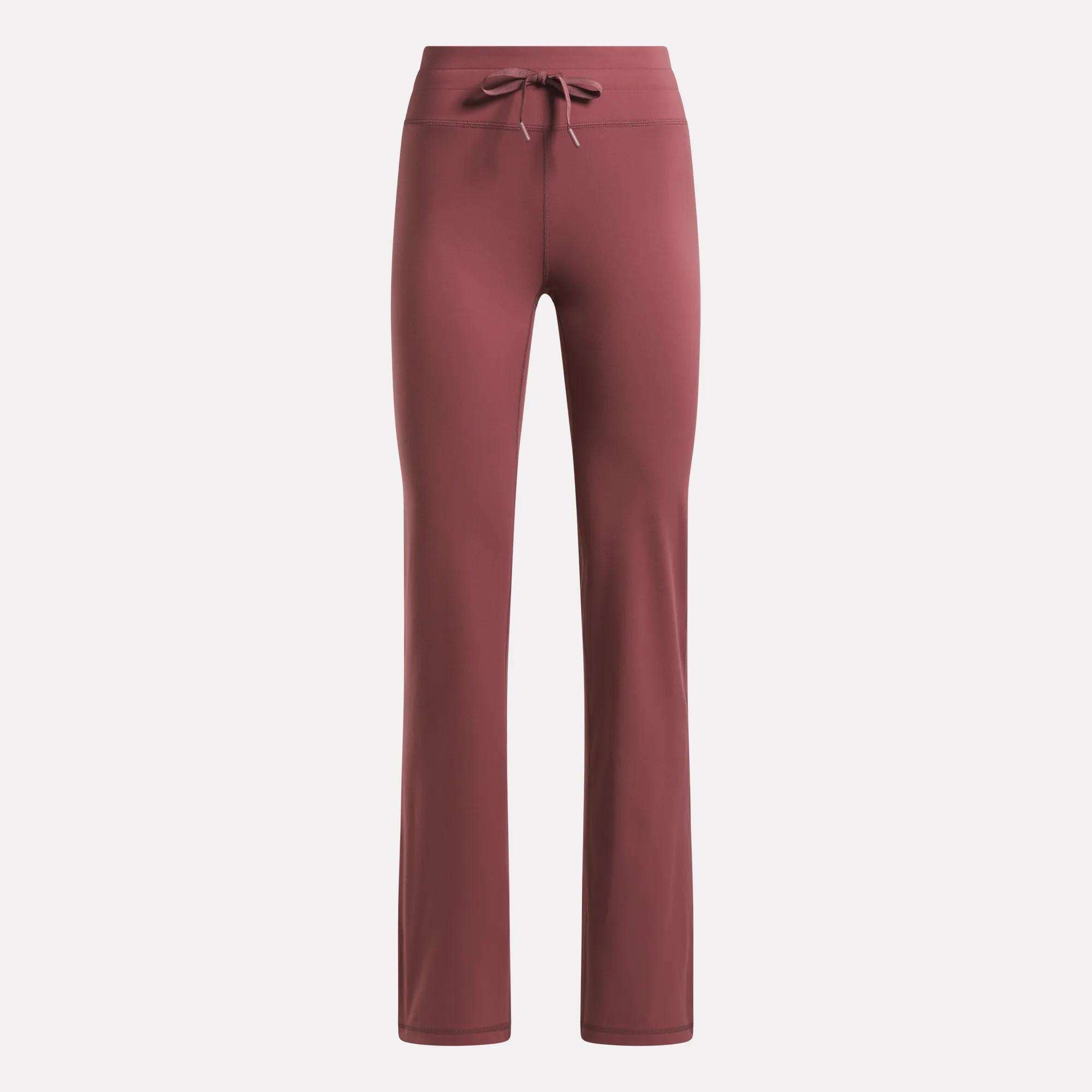 Reebok Women's Highstreet High-Rise Pants in dusty rose feature a straight-leg cut, stretchy fabric, and a drawstring waistband, shown against a plain light background.