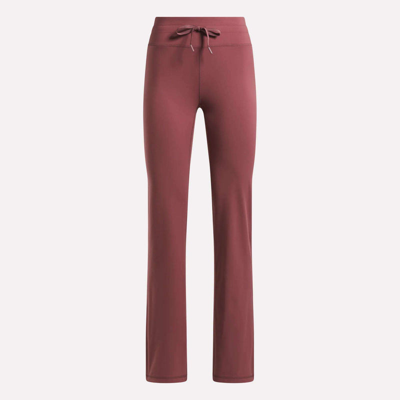 Reebok Women's Highstreet High-Rise Pants in dusty rose feature a straight-leg cut, stretchy fabric, and a drawstring waistband, shown against a plain light background.