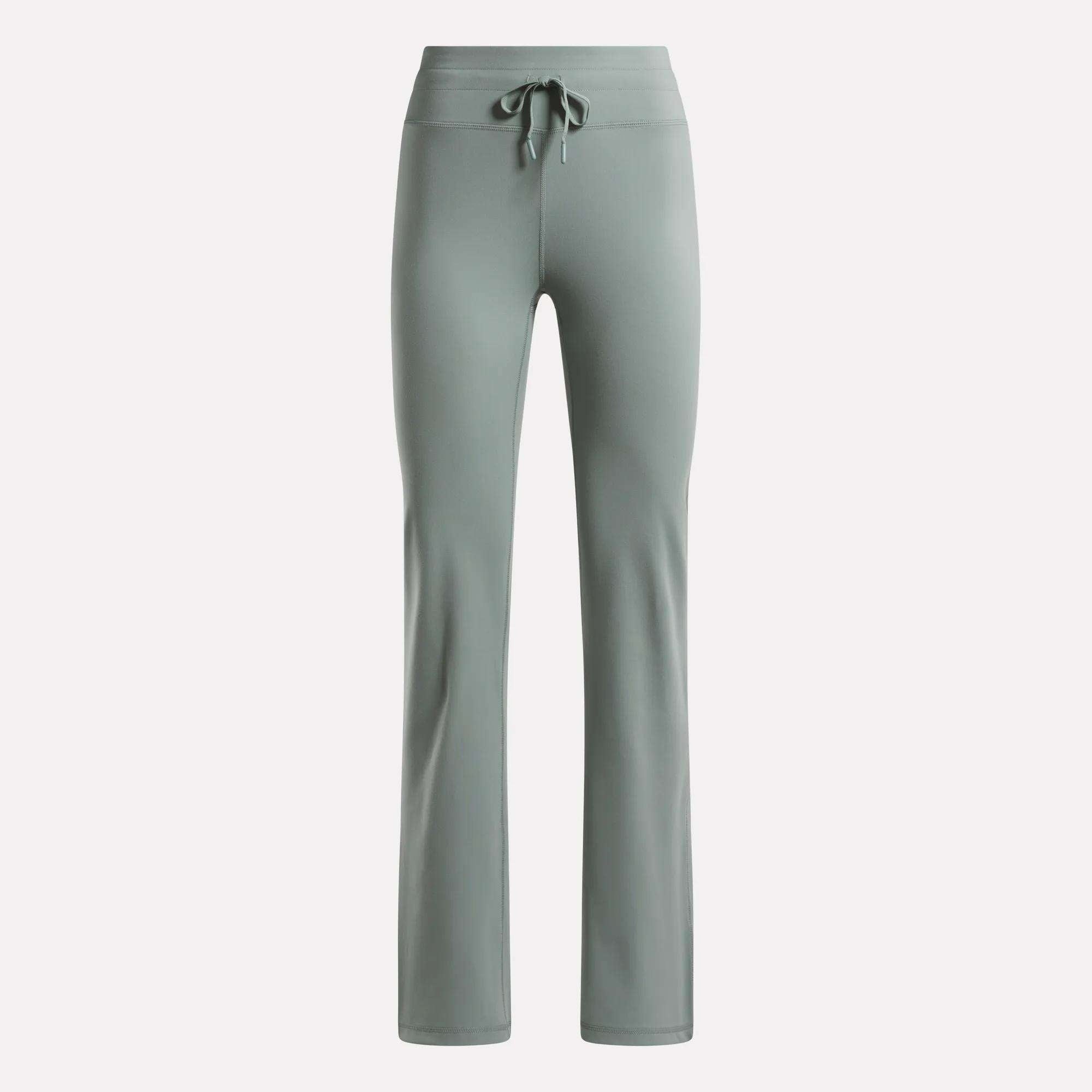 The Reebok Women's Highstreet High-Rise Pants in light sage green feature a drawstring waistband, straight legs, and stretchy fabric for comfort—ideal lounge wear, shown on a plain white background.