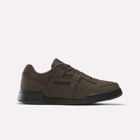An Espresso/Black Reebok Workout Plus shoe with black soles, laces, and a low-cut design is displayed on a plain white background—these iconic shoes embody the classic style of the Workout Plus collection.