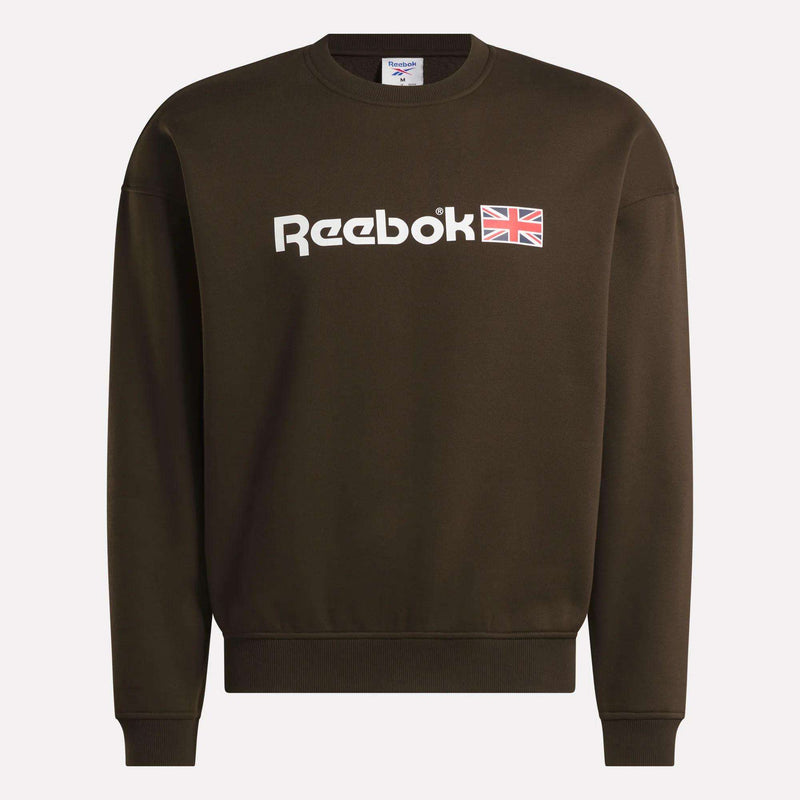 A dark brown Reebok Crewneck Sweatshirt showcasing the brand’s logo and a small Union Jack emblem on the front. This sweatshirt features a relaxed fit, long sleeves, and a classic crew neckline.