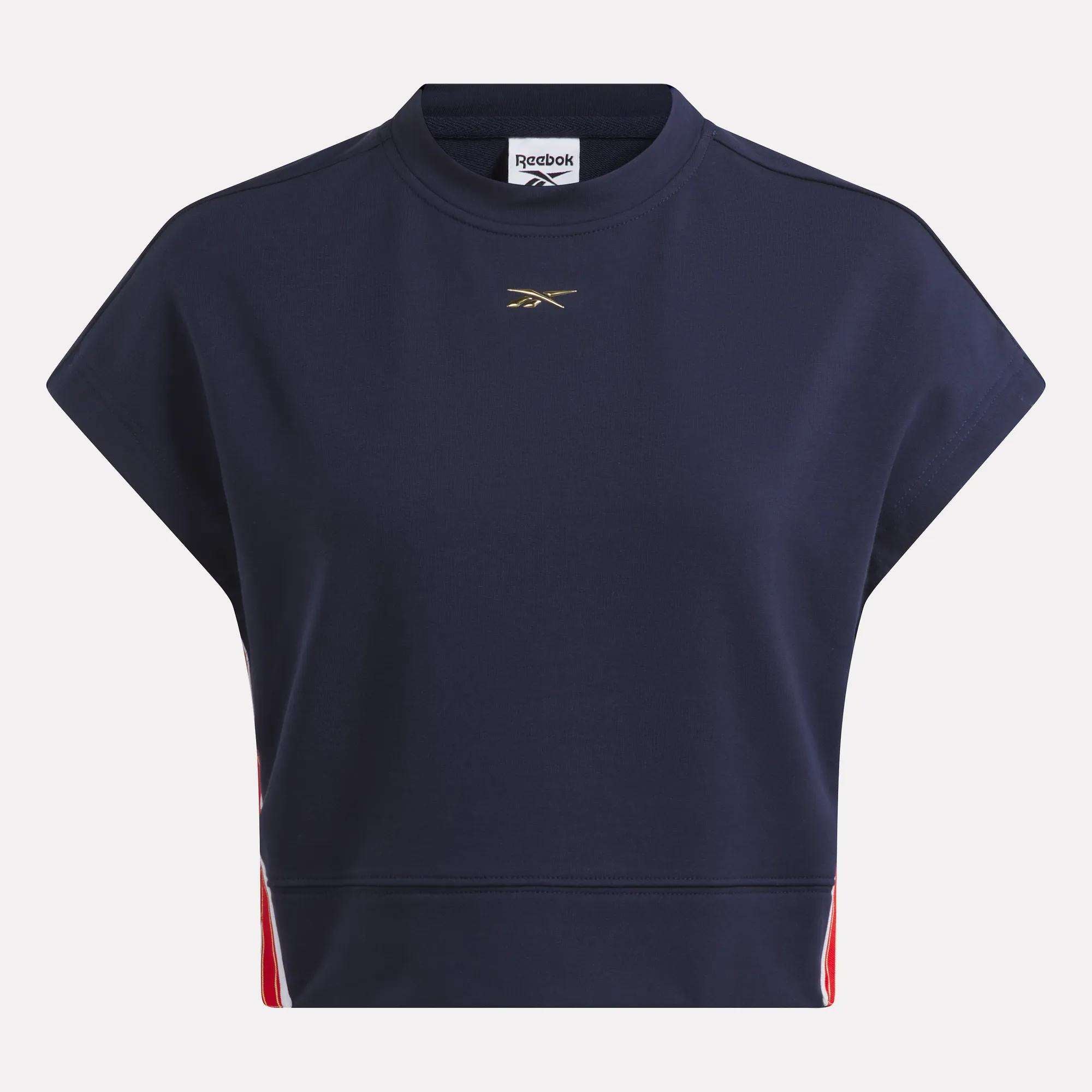 The Reebok Women's Logo Short Sleeve Crewneck Sweatshirt in navy blue features a gold chrome chest logo with red and white side accents, shown on a plain white background.