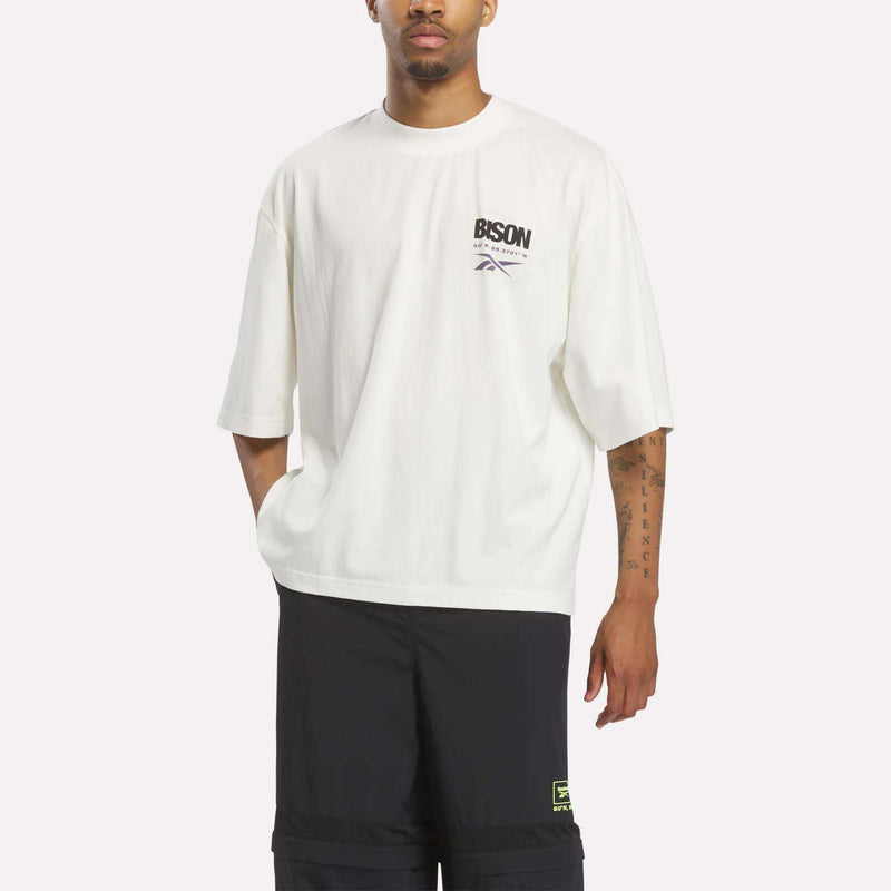 Chalk and black Reebok x A Herd of Bison Graphic Tee with a small logo on the left chest.