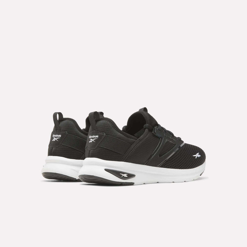 A pair of Reebok Zome Flare Shoes - Big Kids athletic sneakers in black with white soles, shown from the back and side angles against a plain white background. These comfortable Reebok shoes are perfect for kids’ everyday wear and active play.