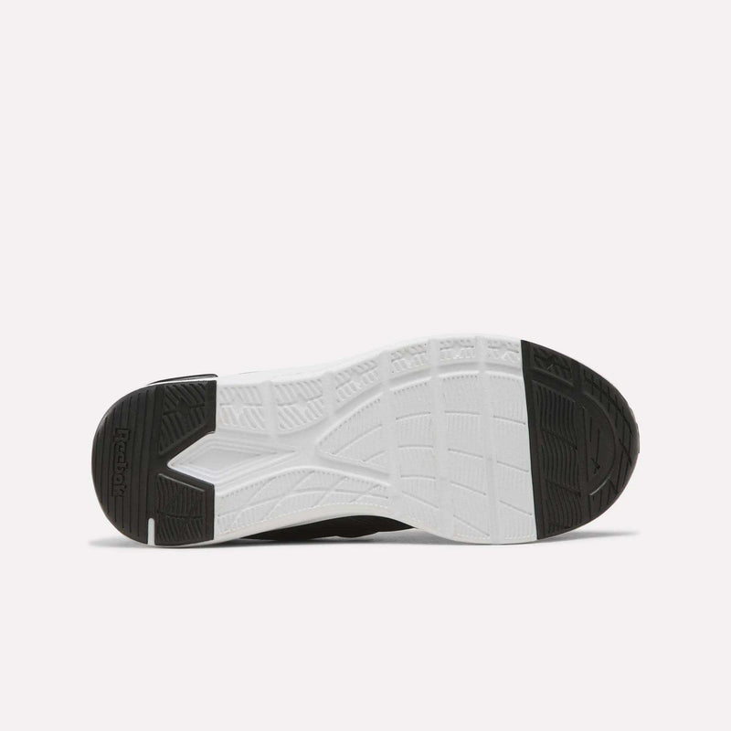 The image displays the sole of the Reebok Zome Flare Shoes - Big Kids, featuring a black heel and toe with a white midsection that has textured, patterned grooves for traction—making these comfortable sneakers an excellent option for active kids.
