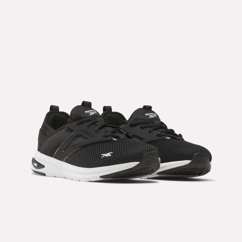 A pair of Reebok Zome Flare Shoes - Big Kids in black with white soles and the signature Reebok logo, showcased on a simple light background—ideal as comfortable everyday footwear for kids.