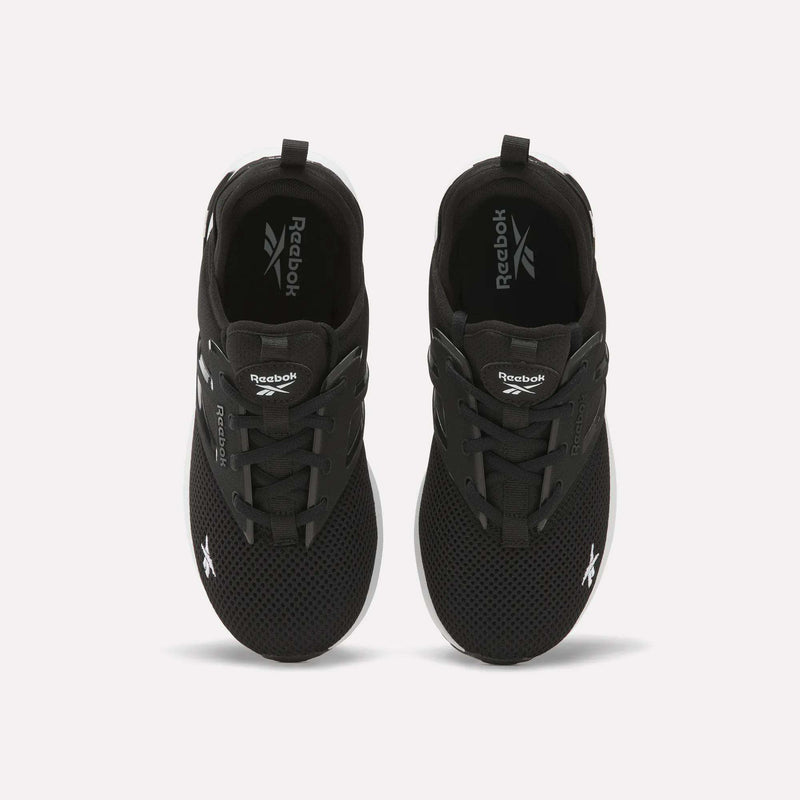 A pair of black Reebok Zome Flare Shoes - Big Kids with white soles, seen from above and featuring the Reebok logo on the tongue and side—these comfortable sneakers are ideal for active children’s days.