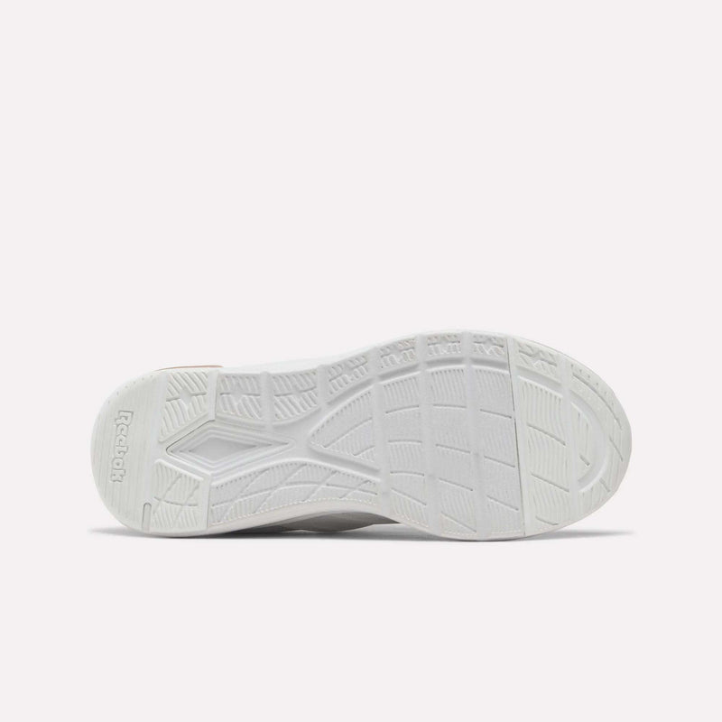 The image displays the white textured sole of the Reebok Zome Flare Shoes - Big Kids, photographed from below against a simple light background, emphasizing its design as a comfortable kids’ sneaker from Reebok.