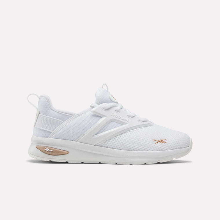 The Reebok Zome Flare Shoes for Big Kids feature a white colorway with a breathable mesh design, white laces, and subtle tan accents on the sole and Reebok logos. Photographed from the side on a plain white background, these sneakers are perfect for anyone seeking comfort and style.