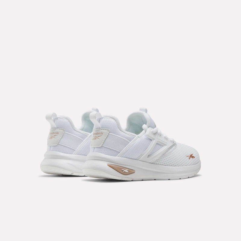 A pair of white Reebok Zome Flare Shoes for little kids is viewed from the back left, featuring mesh uppers, white laces, and subtle gold Reebok logos on the heel and sole. These comfortable sneakers are perfect for active days, with a versatile design ideal for children’s footwear. The shoes are set against a plain white background.