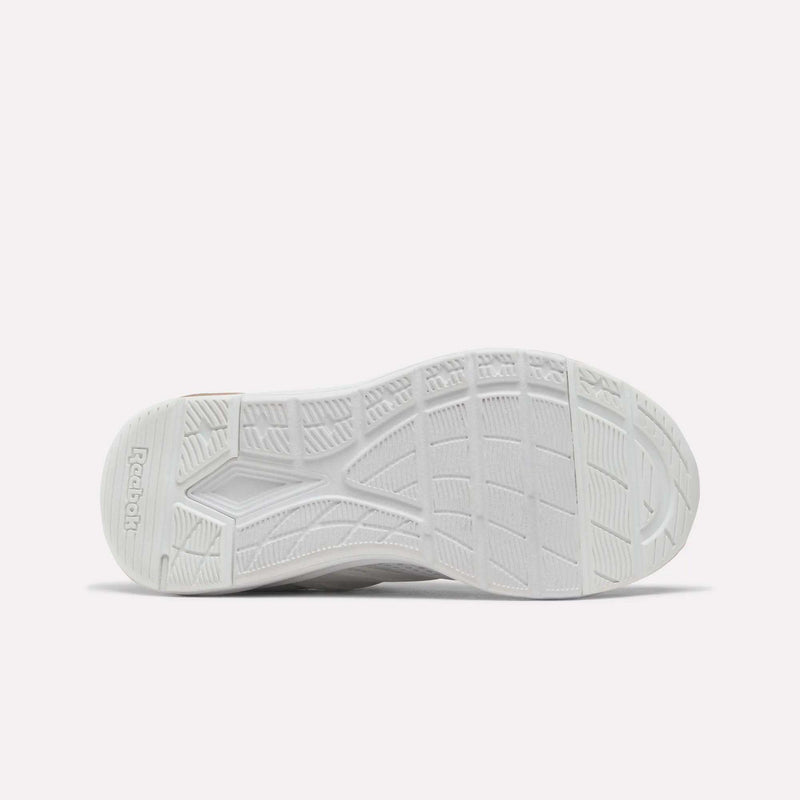 The image displays the white, textured sole of the Reebok Zome Flare Shoes for little kids, viewed from the bottom. The sole is designed with various patterns and grooves to provide excellent traction, featuring Reebok branding on the left side. Crafted for children, these comfortable sneakers deliver superior grip and support, making them ideal for all-day wear.