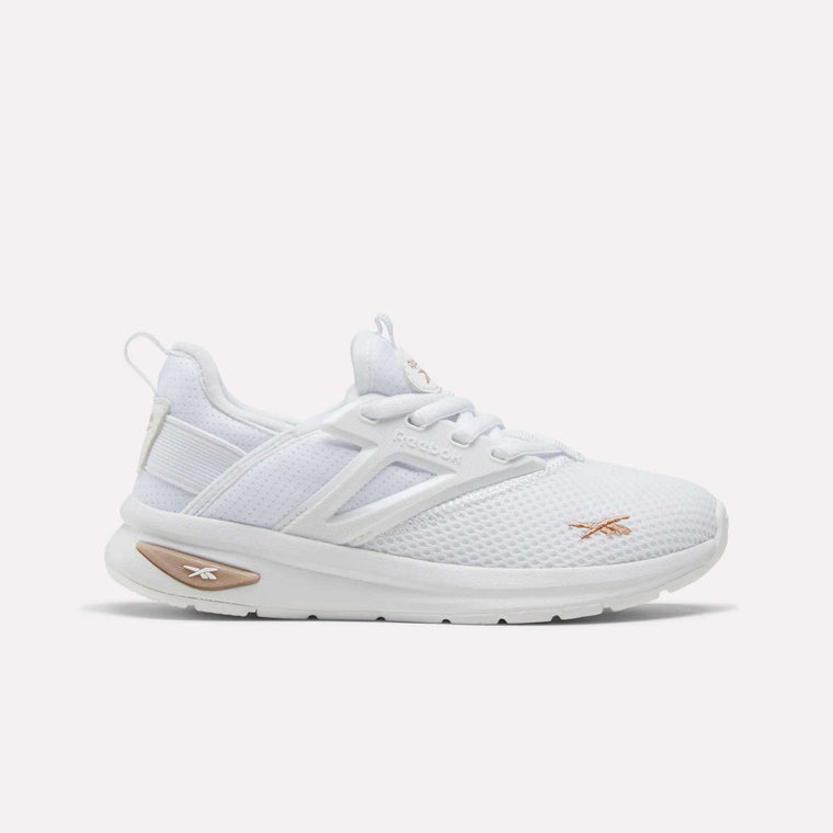 The Zome Flare Shoes for little kids by Reebok are white athletic sneakers designed for comfort, featuring a mesh upper, white sole, and subtle light beige accents on the side and heel. The Reebok logo appears on both the side and tongue. The shoes are shown against a plain white background.