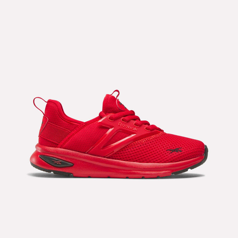 The Zome Flare Shoes – Little Kids by Reebok are bright red athletic sneakers featuring mesh fabric, laces, and a black rubber sole. Designed for lightweight comfort, these shoes display the Reebok logo on the side and toe. The product is shown against a plain white background.