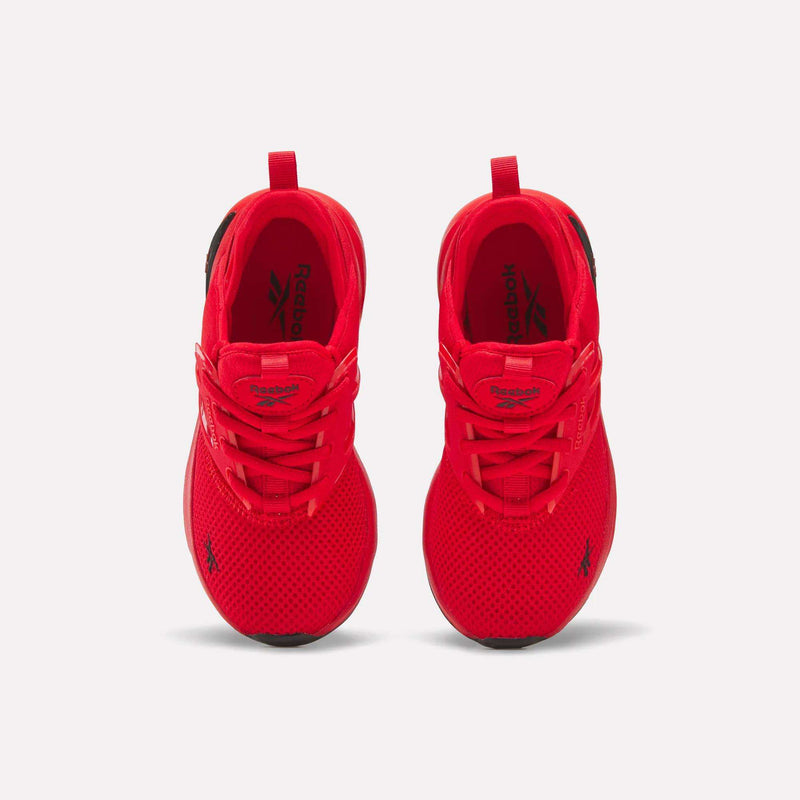 A pair of Zome Flare Shoes - Little Kids by Reebok, showcased from above in vibrant red, featuring bold black Reebok logos on the tongues and sides. These comfortable sneakers include matching red laces and soles, arranged side by side against a white background.