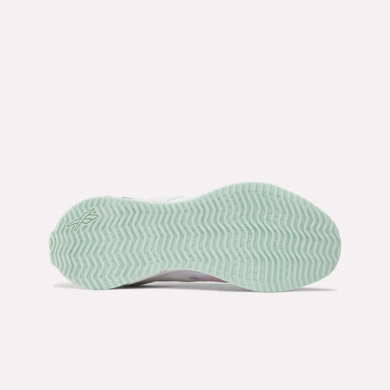 Bottom view of the Reebok Pyro Storm Shoes - Big Kids, featuring a light green sole with a wavy, zigzag tread pattern and a small Reebok logo near the heel. Designed for comfort and flexibility, these lightweight running shoes are perfect for active little feet.