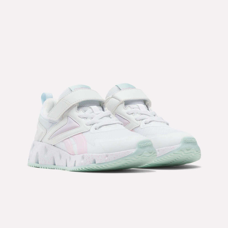 A pair of Reebok Pyro Storm Shoes for big kids in white, accented with light blue, pink, and mint green details, featuring thick soles and convenient velcro straps for easy wear, displayed side by side on a white background.