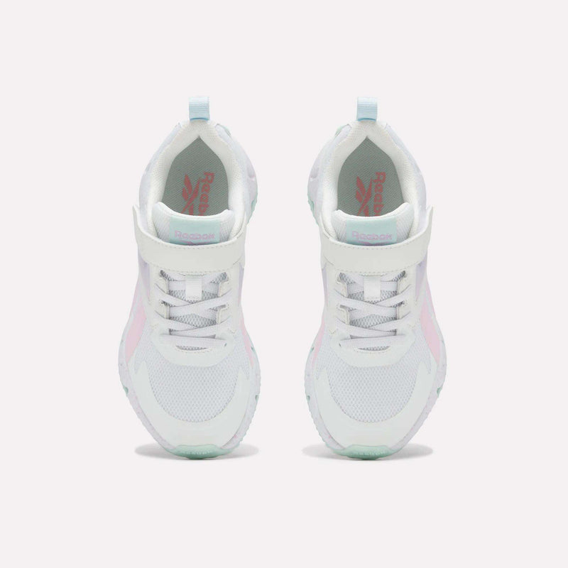 Top view of a pair of Reebok Pyro Storm Shoes - Big Kids in white, featuring light pink accents, light blue heel tabs, and white laces on a plain white background. These lightweight shoes are crafted for comfort and style.