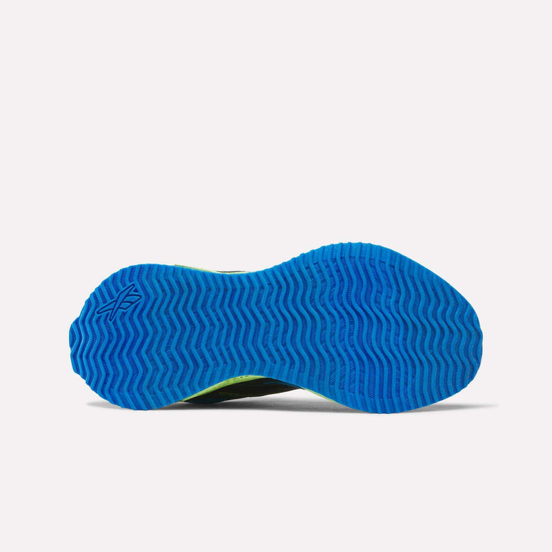 The image displays the bottom view of the Reebok Pyro Storm 1V Shoes for little kids, highlighting a bright blue durable rubber outsole with a herringbone tread pattern set against a white background.