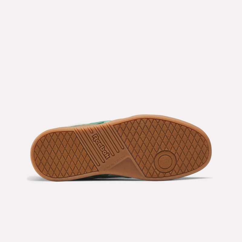 The image displays the brown rubber sole of the Reebok Forte Pitch Shoes - Big Kids sneaker, viewed from the bottom, featuring a textured diamond pattern and the Reebok logo in the center.