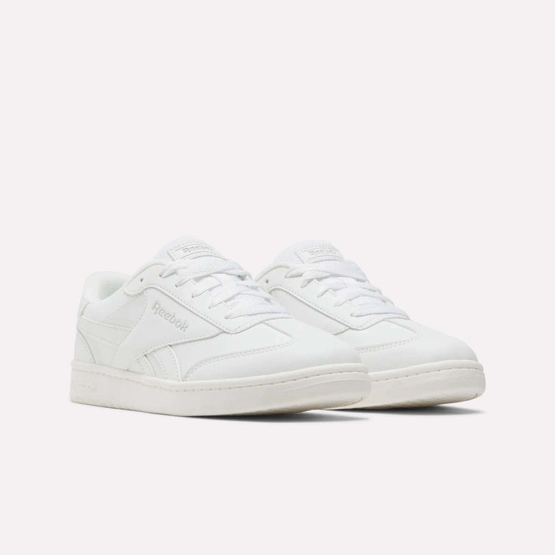 A pair of Reebok Forte Pitch Shoes - Big Kids in classic white, showcasing a court-inspired sneaker design with coordinating white laces and soles, displayed against a plain white background.
