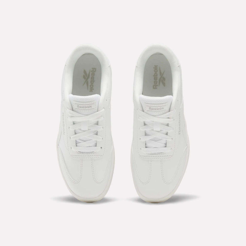 A pair of Reebok Forte Pitch Shoes - Big Kids in white, seen from above, featuring classic laces and the Reebok logo on the insoles. These court-inspired sneakers deliver timeless style and everyday comfort.