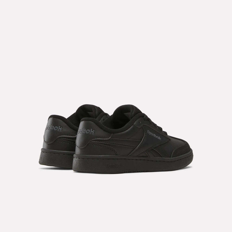 A pair of Reebok Forte Pitch Shoes - Little Kids in black are positioned on a white background, angled to display both the side and back views, highlighting the brand logo and classic court-inspired sneaker design.